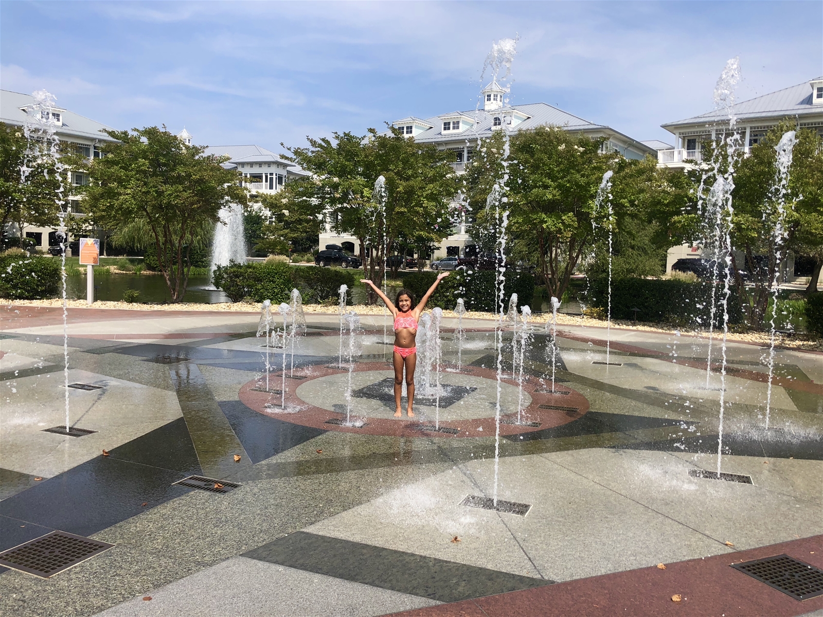 A little girl enjoying a play fountain in Sunset Island MD